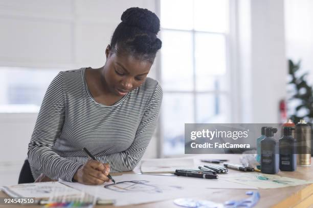 graphic designer working in modern studio space - fashion day at the artists project stock pictures, royalty-free photos & images