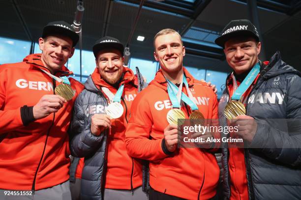 Man Boblseigh olympic champions Francesco Friedrich, Candy Bauer, Martin Grothkopp and Thorsten Margis pose with their gold medals during the welcome...