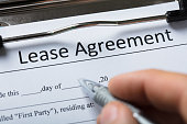 Human Hand Filling Lease Agreement Form