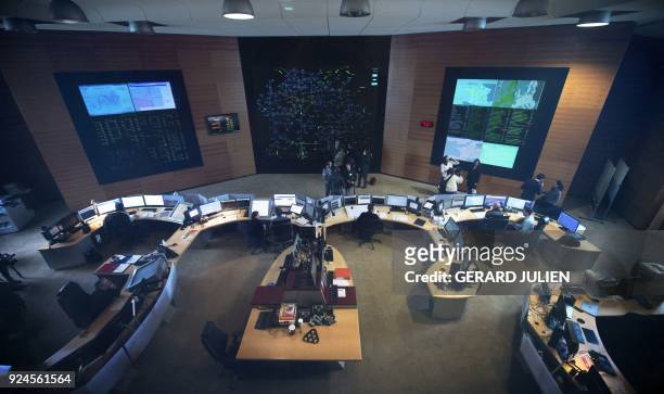 Employees work at the dispatching room of the national operating center of French electricity transport network operator RTE on February 26, 2018 in...
