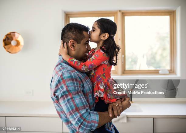 daughter kissing father at home - indian child fotografías e imágenes de stock