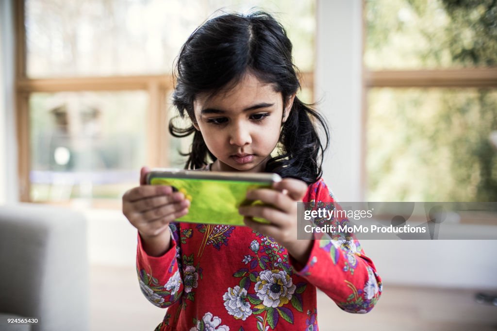 Young girl using smartphone at home