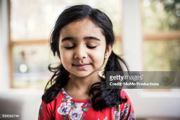 Portrait of hopeful young girl at home