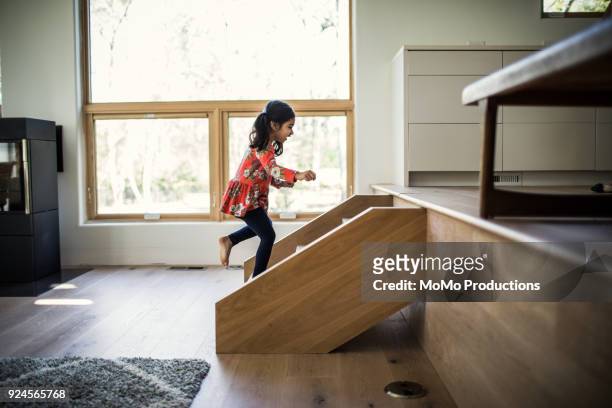 young girl running up steps at home - child running up stairs stock pictures, royalty-free photos & images