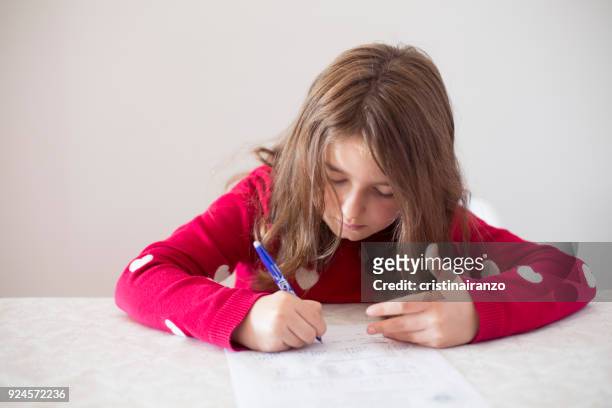 little girl doing homework at home - subtraction stock pictures, royalty-free photos & images