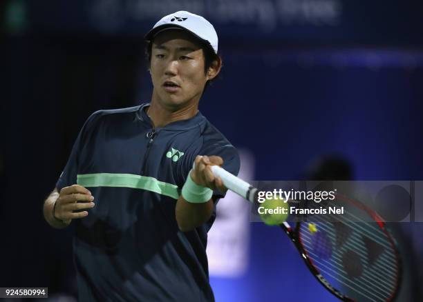 Yoshihito Nishioka of Japan plays a forehand in match against Benoit Paire of France during day one of the ATP Dubai Duty Free Tennis Championships...