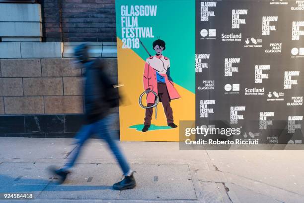 Person passes in front of GFF poster during the 14th Glasgow Film Festival on February 26, 2018 in Glasgow, Scotland.