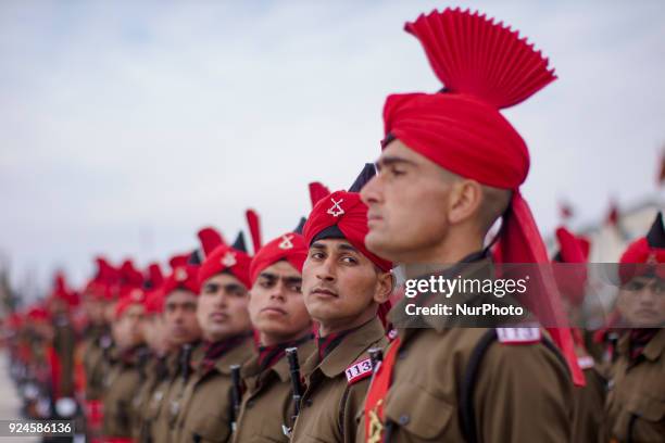 The recruits of Indian army from Kashmir stand in formation during their passing out parade at a garrison in Rangreth on February 26, 2018 in the...