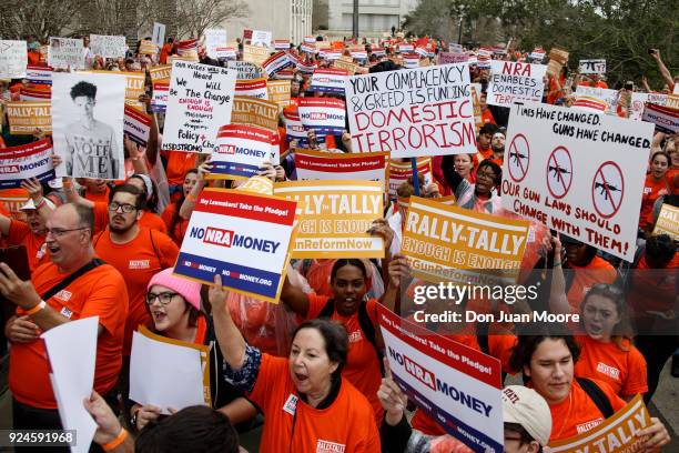 Activists hold up signs at the Florida State Capitol as they rally for gun reform legislation on February 26, 2018 in Tallahassee, Florida. In the...