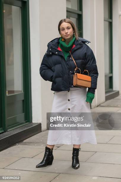 Sunday Times Style fashion writer Lila Flint Roberts wears Office boots, River Island jumper, Topshop Boutique coat, Danse Lente bag and a Nanushka...