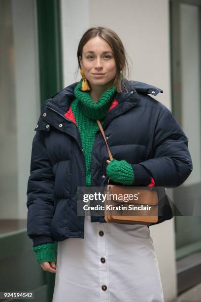 Sunday Times Style fashion writer Lila Flint Roberts wears a River Island jumper, Topshop Boutique coat, Danse Lente bag and a Nanushka skirt on day...