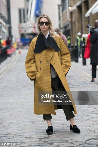 Editor in chief of MINT magazine Irina Lakicevic wears a Pringle of Scotland jacket, Burberry trousers and The Stores shoes on day 5 of London Womens...