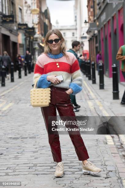 Digital influencer Lucy Williams wears a Shrimps jumper and bag, Le Specs sunglasses, Isa Arfen trousers and Nike trainers on day 5 of London Womens...