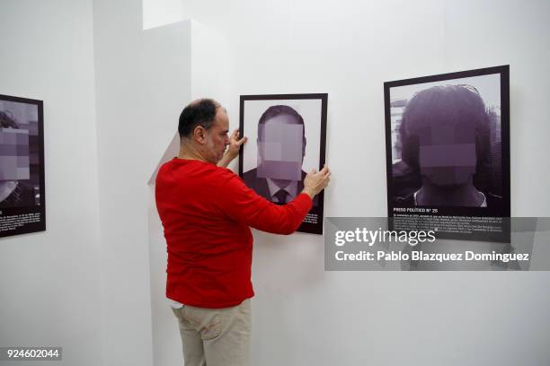 Man sets up a picture depicting jailed Catalan leader Oriol Junqueras before the presentation of Spanish artist Santiago Sierra's work 'Political...