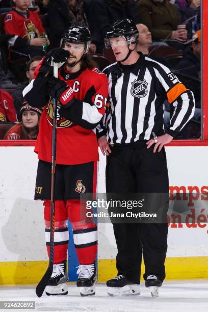 Referee Kevin Pollock chats with Erik Karlsson of the Ottawa Senators during a game against the Philadelphia Flyers at Canadian Tire Centre on...