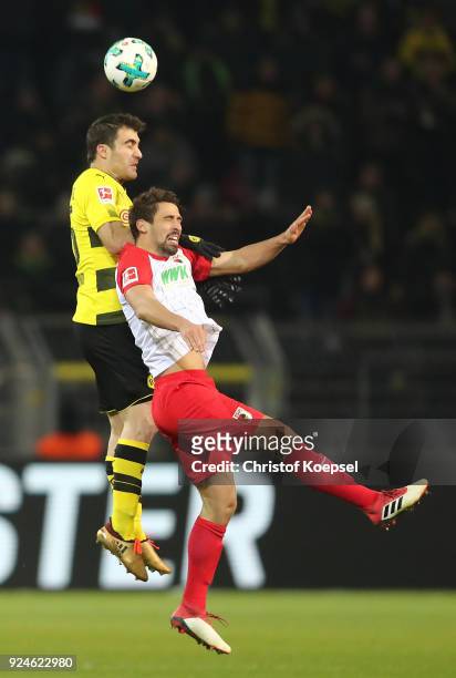 Sokratis of Dortmund is challenged by Rani Khedira of Augsburg during the Bundesliga match between Borussia Dortmund and FC Augsburg at Signal Iduna...