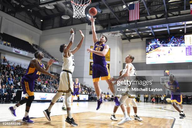 Greig Stire of the Albany Great Danes drives to the basket during a college basketball game against the UMBC Retrievers at the Events Center on...