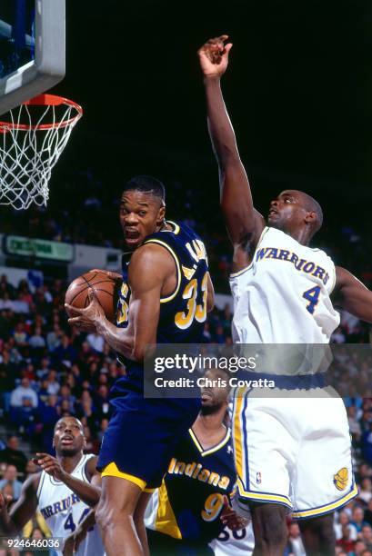 Antonio Davis of the Indiana Pacers rebounds during a game played on December 4, 1993 at the Arena in Oakland in Oakland, California. NOTE TO USER:...