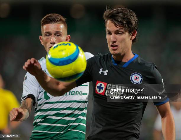 Carlos Fierro of Cruz Azul controls the ball observed by Brian Lozano of Santos during the 9th round match between Santos Laguna and Cruz Azul as...