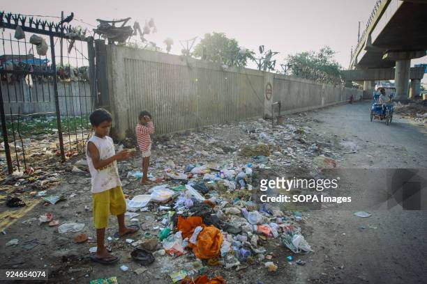 Children from the slum seen playing next to a pile of rubbish. Over 25 million people live in Delhi, India. What is particularly problematic in India...