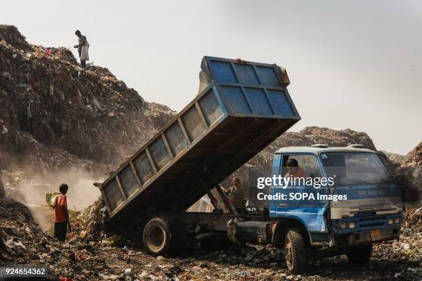 Rubbish truck seen unloading rubbish near a slum. Over 25 million people live in Delhi, India. What is particularly problematic in India is...