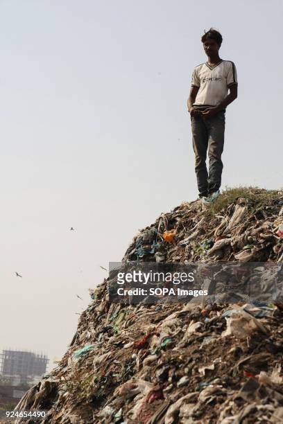 Man seen standing on a pile of rubbish. Over 25 million people live in Delhi, India. What is particularly problematic in India is environmental issue...