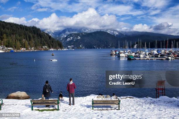 couple enjoying the view of seascape in deep cove - the blue man group in vancouver stock pictures, royalty-free photos & images