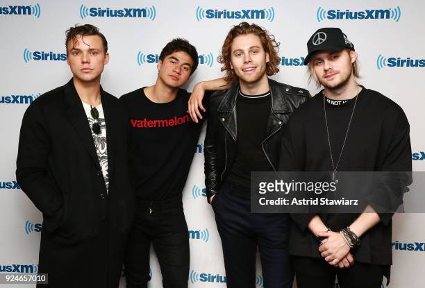 Musicians Ashton Irwin, Calum Hood, Luke Hemmings and Michael Clifford of 5 Seconds of Summer pose for photos during a town hall at the SiriusXM...