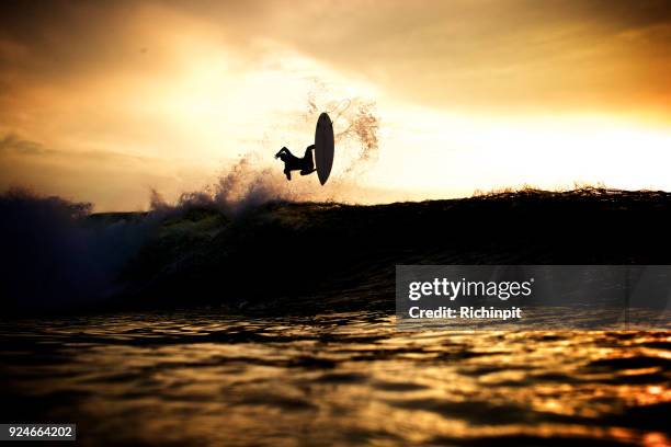 surfer takes to the sky - flippers stock pictures, royalty-free photos & images