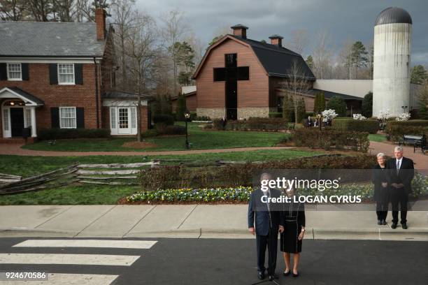 Former US President George W. Bush and First Lady Laura Bush address the media at The Billy Graham Library after meeting with Franklin Graham and his...