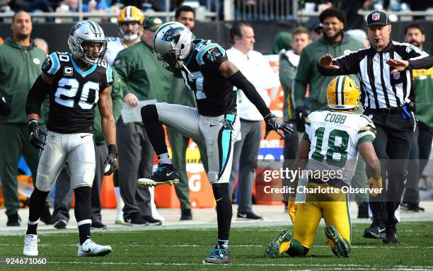 Carolina Panthers cornerback Kevon Seymour, center, celebrates his stop of Green Bay Packers wide receiver Randall Cobb's attempt at catching a pass...
