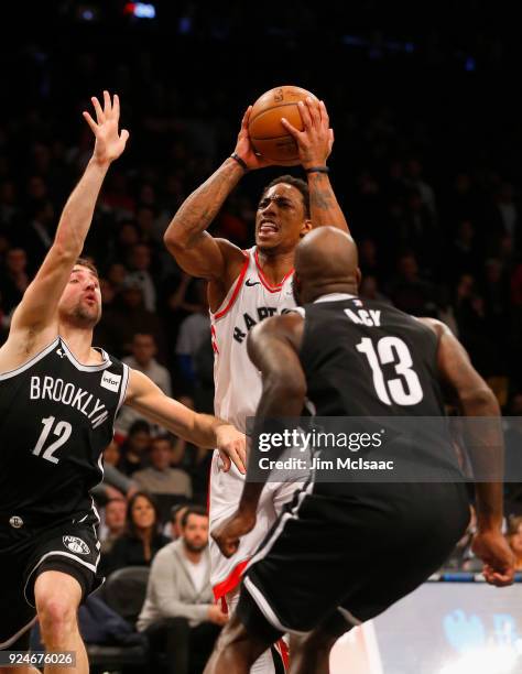 DeMar DeRozan of the Toronto Raptors in action against Joe Harris and Quincy Acy of the Brooklyn Nets at Barclays Center on January 8, 2018 in the...