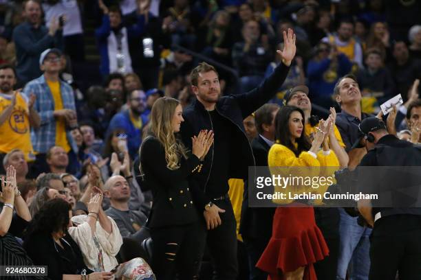 Former Golden State Warriors player David Lee is introduced to the crowd while his fiancée Caroline Wozniacki looks on during the game between the...