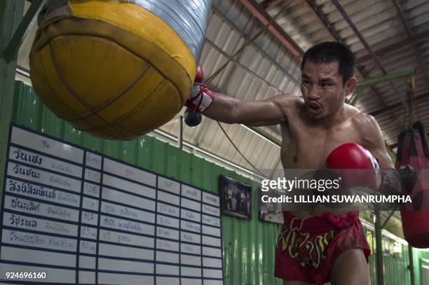 This photo taken on January 31, 2018 shows the current World Boxing Council mini-flyweight champion, Wanheng Menayothin, punching a bag during a...