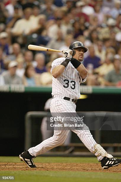 Larry Walker of the Colorado Rockies watches his home run fly to the right field bleachers against the San Francisco Giants in the second inning at...