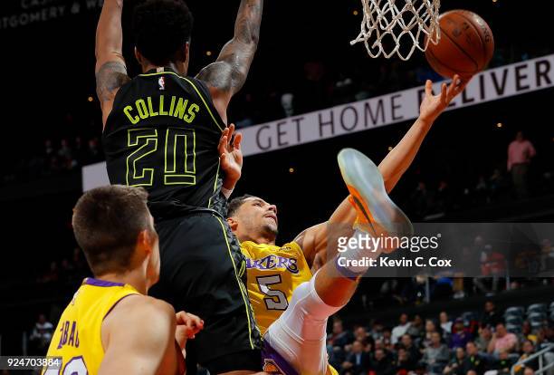 Josh Hart of the Los Angeles Lakers attacks the basket against John Collins of the Atlanta Hawks at Philips Arena on February 26, 2018 in Atlanta,...