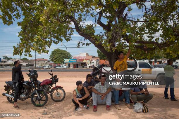 Venezuelan mason Carlos Malave awaits along with his other five relatives in front of Boa Vista's Federal Police headquarters to ask for papers to...