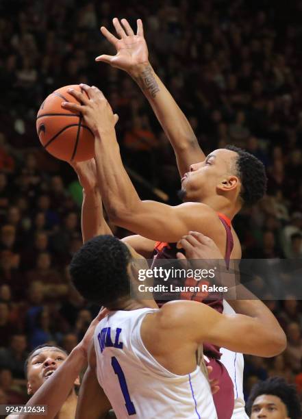 Justin Robinson of the Virginia Tech Hokies shoots against Trevon Duval of the Duke Blue Devils during the game at Cassell Coliseum on February 26,...