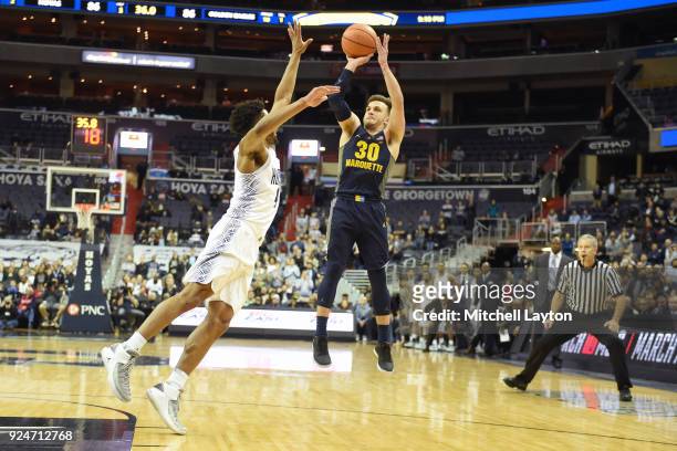 Andrew Rowsey of the Marquette Golden Eagles takes the winning shot over Jagan Mosely of the Georgetown Hoyas during a college basketball game at the...