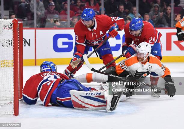 Charlie Lindgren of the Montreal Canadiens makes a save in front of Claude Giroux of the Philadelphia Flyers in the NHL game at the Bell Centre on...