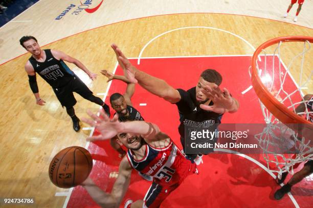 Tomas Satoransky of the Washington Wizards shoots the ball against Michael Carter-Williams of the Charlotte Hornets during the game between the two...