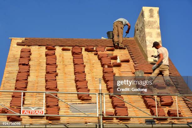 Workers on a roof. France. .