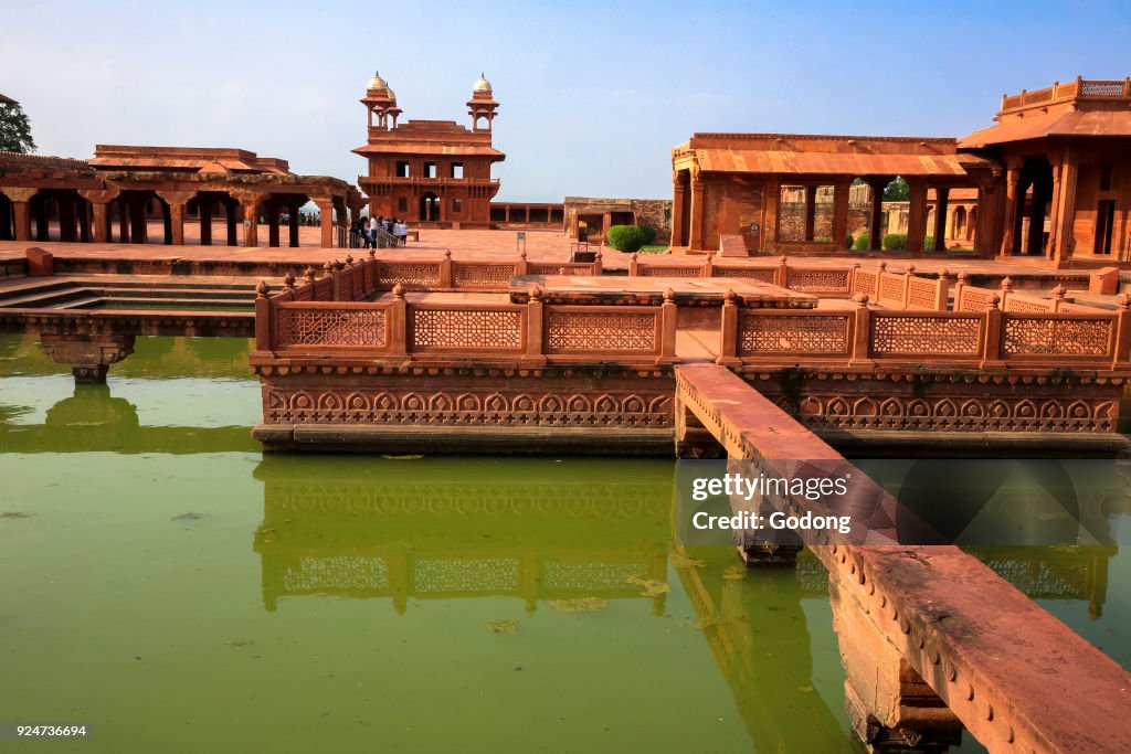 Fatehpur Sikri, founded in 1569 by the Mughal Emperor Akbar, served as the capital of the Mughal Empire from 1571 to 1585.  Imperial Palace complex. Anup Talao, an ornamental pool with a central platform and four bridges leading up to it.  India.
