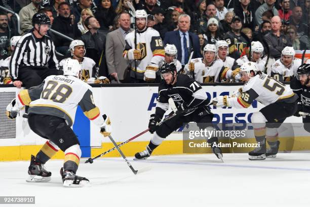 Torrey Mitchell of the Los Angeles Kings handles the puck against Erik Haula and Nate Schmidt of the Vegas Golden Knights at STAPLES Center on...