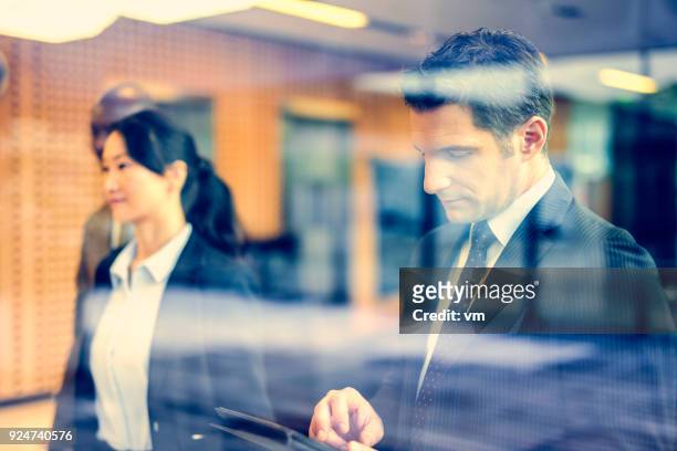businessman using digital tablet - hedge fund stock pictures, royalty-free photos & images