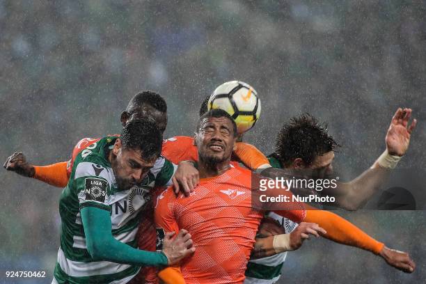 Moreirense's defender Iago Santos heads the ball in the middle of Sporting's defender Andre Pinto , and Sporting's defender Sebastian Coates during...