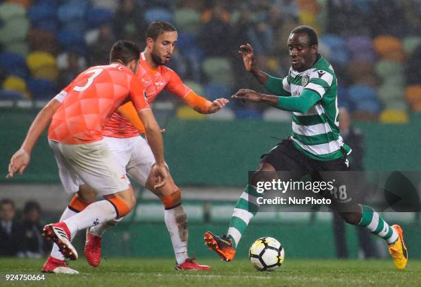 Sporting's forward Seydou Doumbia vies with Moreirense's defender Andre Micael and Moreirense's defender Mohamed Aberhoune during the Portuguese...