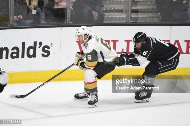 Colin Miller of the Vegas Golden Knights handles the puck against Jake Muzzin of the Los Angeles Kings at STAPLES Center on February 26, 2018 in Los...