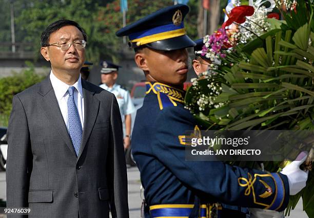 Chinese Foreign Minister Yang Jiechi attends a wreath-laying ceremony at the monument of Philippine national hero Jose Rizal in Manila on October 29,...