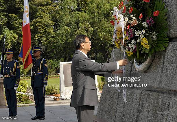 Chinese Foreign Minister Yang Jiechi lays a wreath during a visit to the monument of Philippine national hero Jose Rizal in Manila on October 29,...